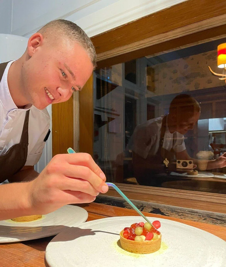 Chef Adam Detheridge plating a dessert