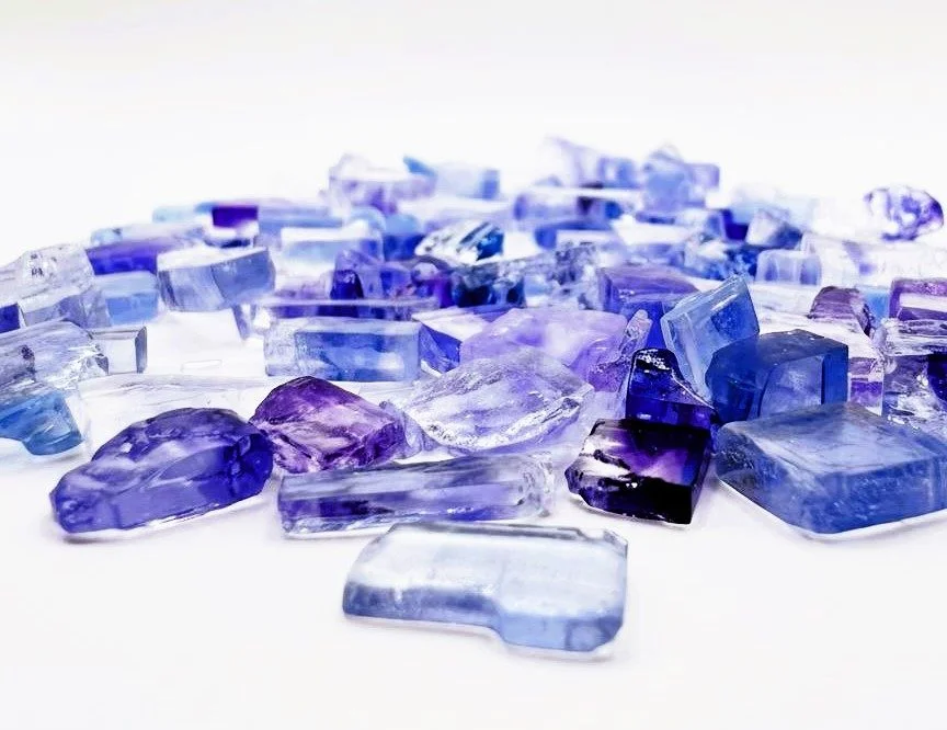 Electric-blue salt crystals close-up on a white background