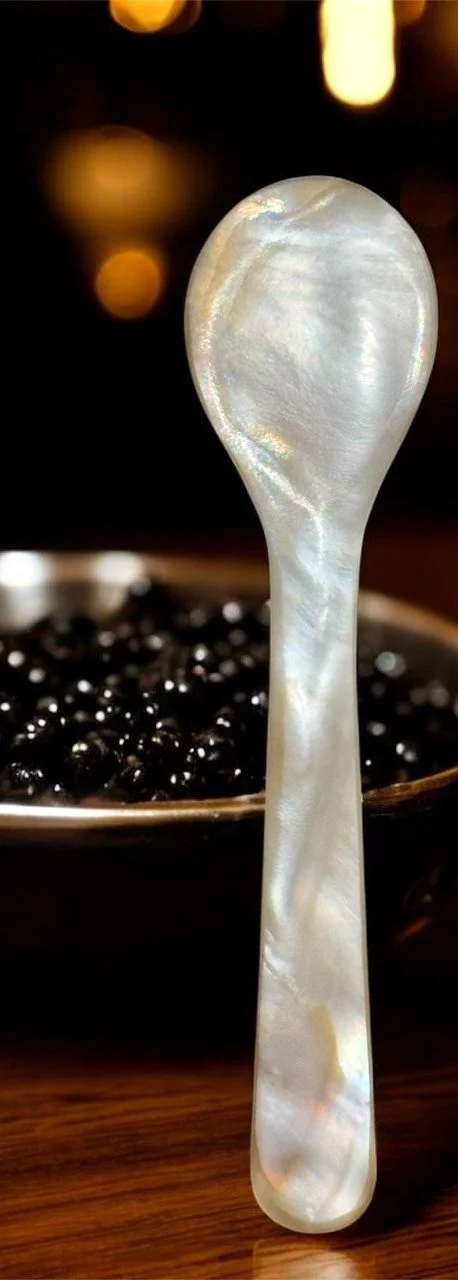 Mother-of-pearl spoon resting in caviar